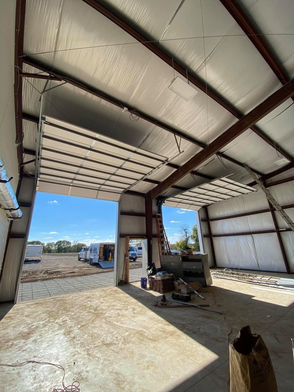Interior view of an insulated overhead door track system in a steel building