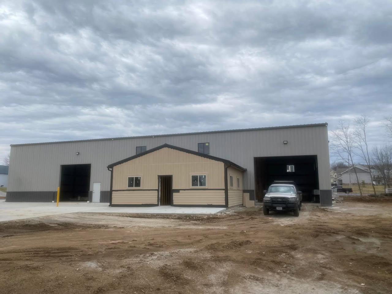 Metal shop building with commercial overhead doors installed by Carlisle Overhead Doors